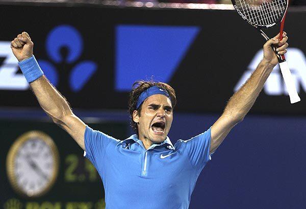 Roger Federer of Switzerland celebrates after defeating Andy Murray of Britain to win the men's singles final match at the Australian Open tennis championship on Sunday.