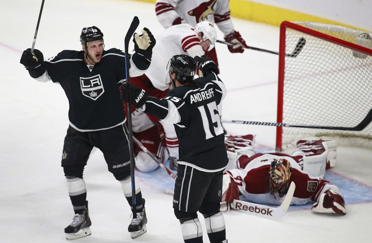 Kings forward Andy Andreoff (15) celebrates with teammates Kyle Clifford after Andreoff's first career goal beat Coyotes goal Mike Smith on Monday.