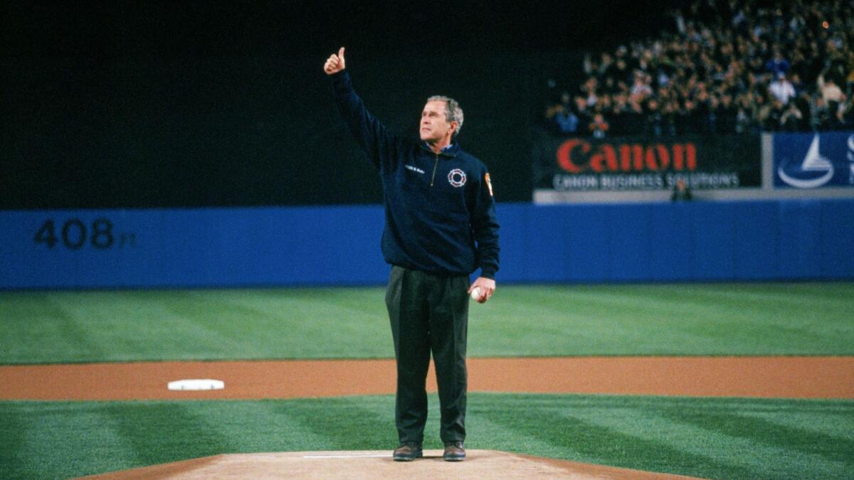 President George W. Bush gives a thumbs up at the ceremonial first pitch prior ot Game Three of the 2001 World Series between the Arizona Diamondbacks and the New York Yankees at Yankee Stadium on October 30, 2001.