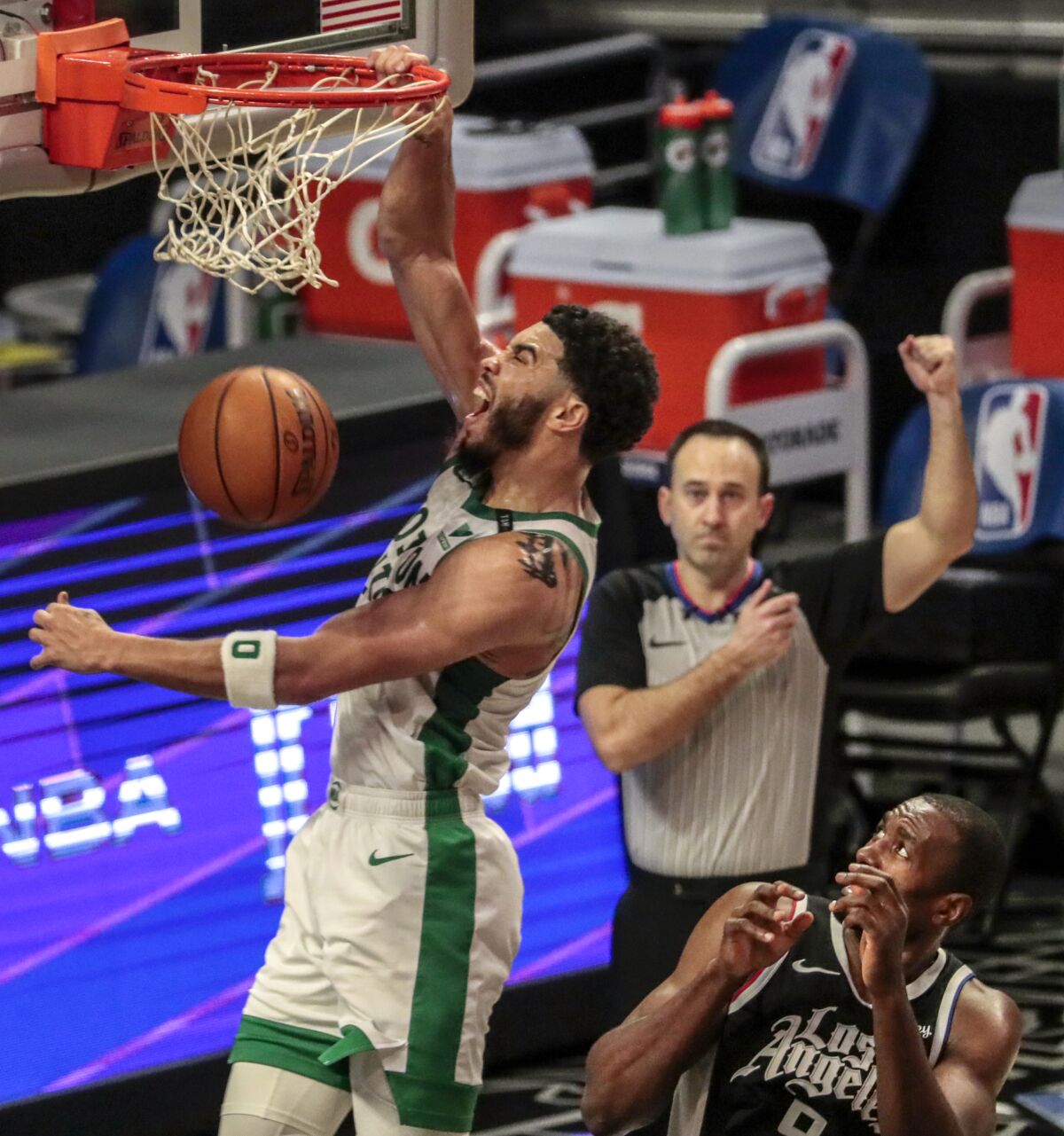 The Celtics' Jayson Tatum dunks over the Clippers' Kawhi Leonard late in the first half at Staples Center. 