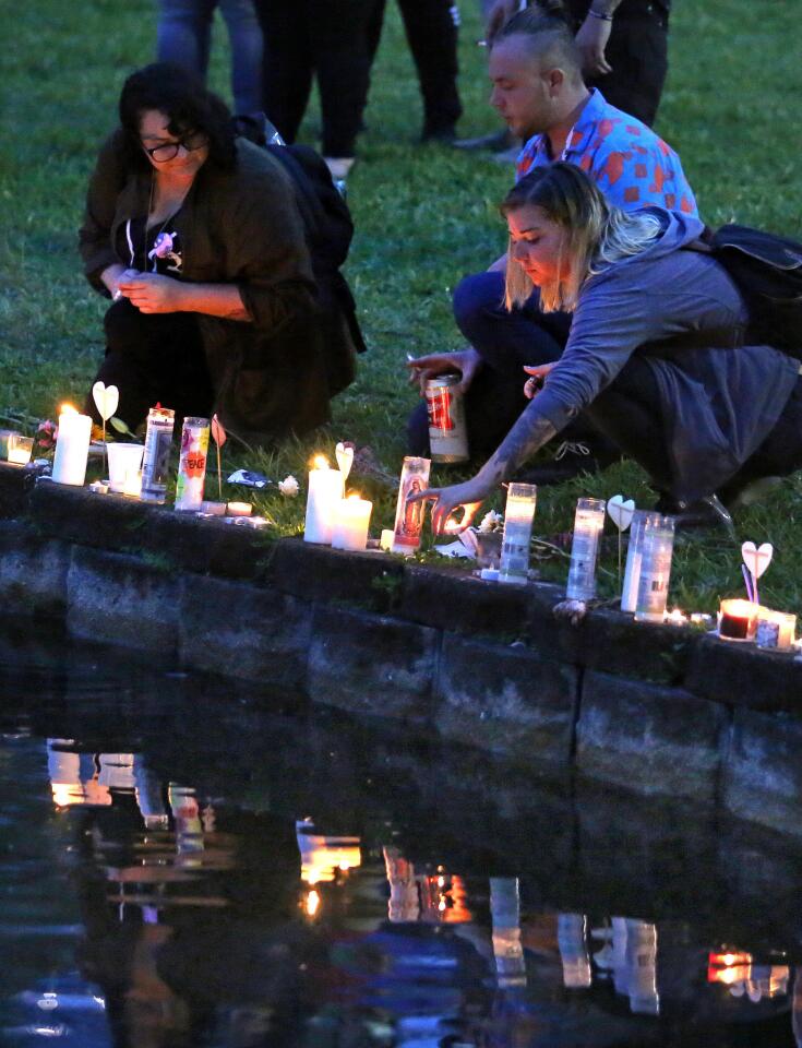 Mourners light chandles along the shoreline of Lake Eola in downtown Orlando, Fla., to honor the victims of the Pulse massacre, Saturday evening, June 18, 2016.