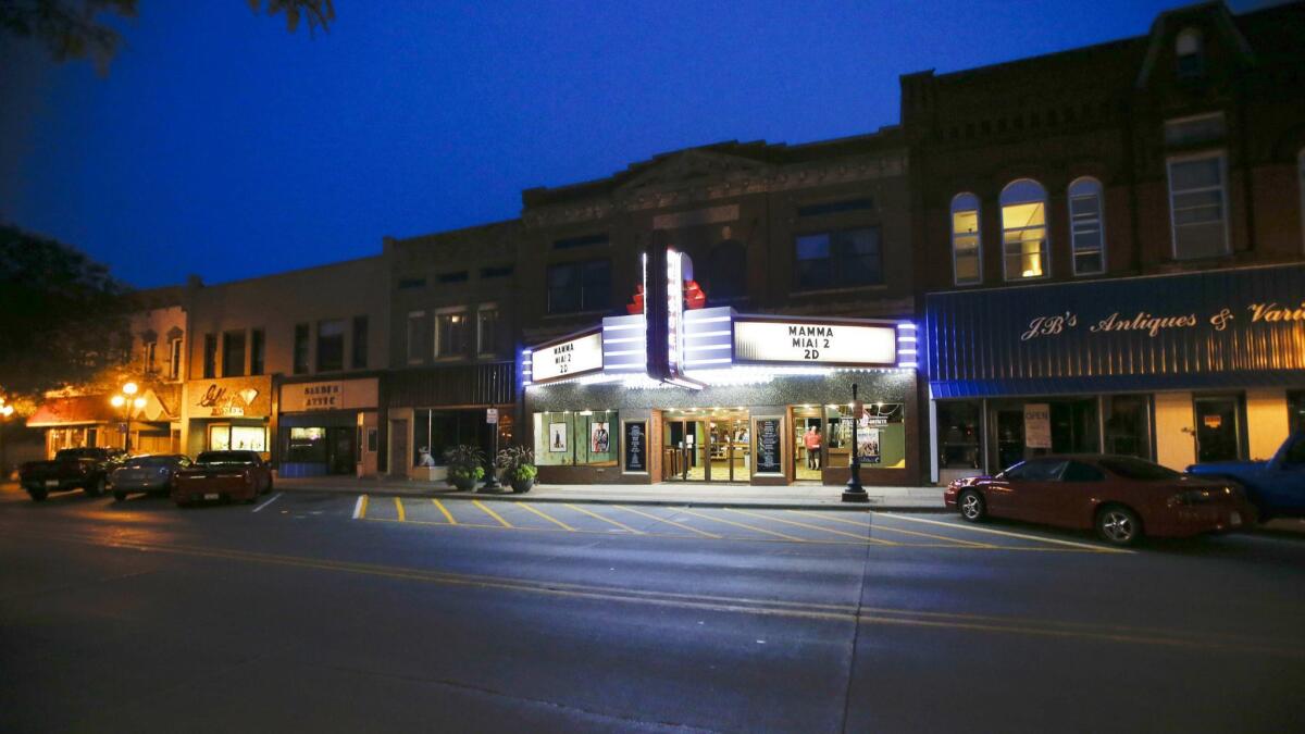 WEBSTER CITY, IA, AUGUST 18, 2018: The marquee is lit up for the seven o'clock showing of "Mamma Mia 2" at the Webster Theater in Webster City, Iowa Saturday, Aug. 18, 2018. Community members rallied around the theater to save it after it closed in 2013. (Rebecca F. Miller / For The Times)