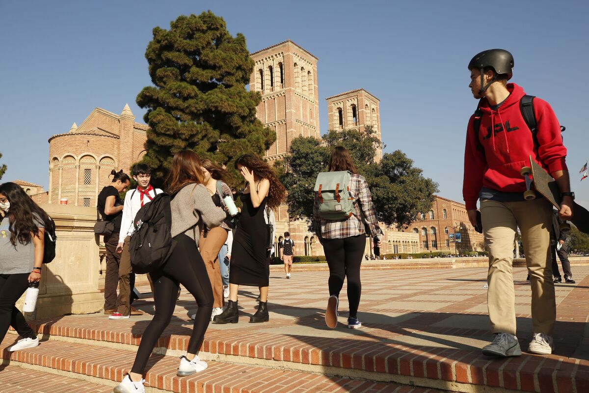 Nov. 2021 photo of student navigating the UCLA campus near Royce Hall. 