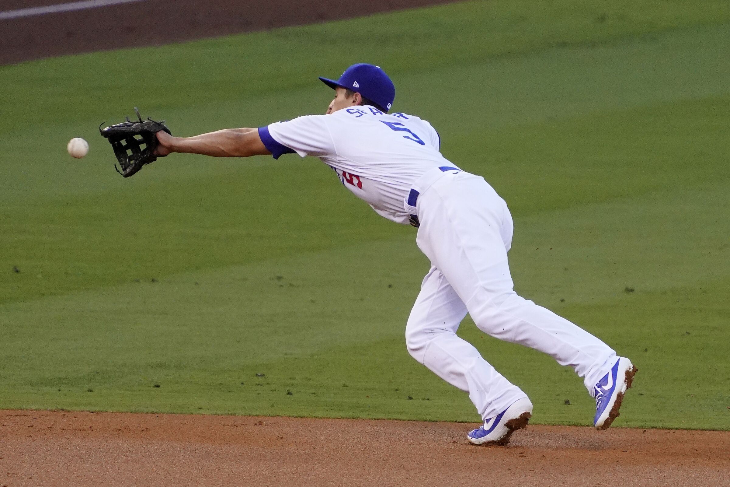 Dodgers shortstop Corey Seager can't reach a ball hit by the Giants on Aug. 7, 2020.