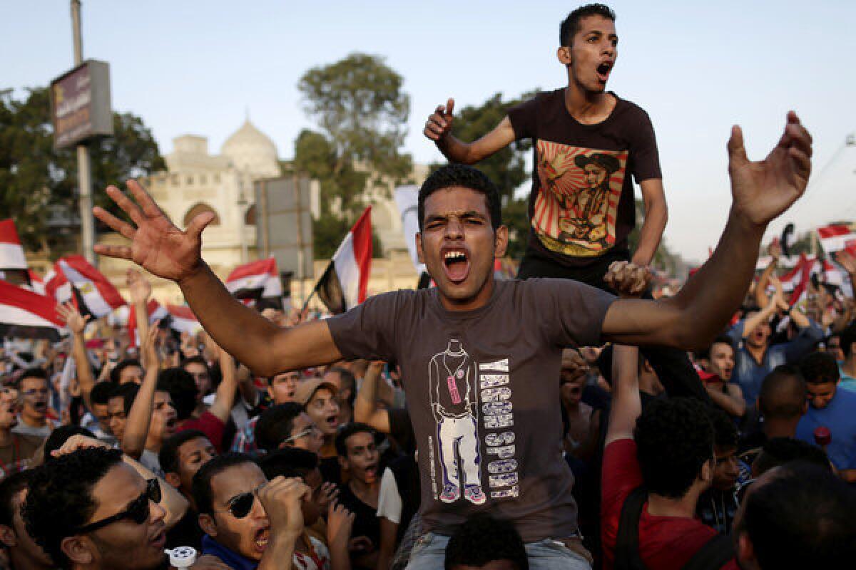 Opponents of Egyptian President Mohamed Morsi chant slogans during a protest outside the presidential palace in Cairo on Monday.