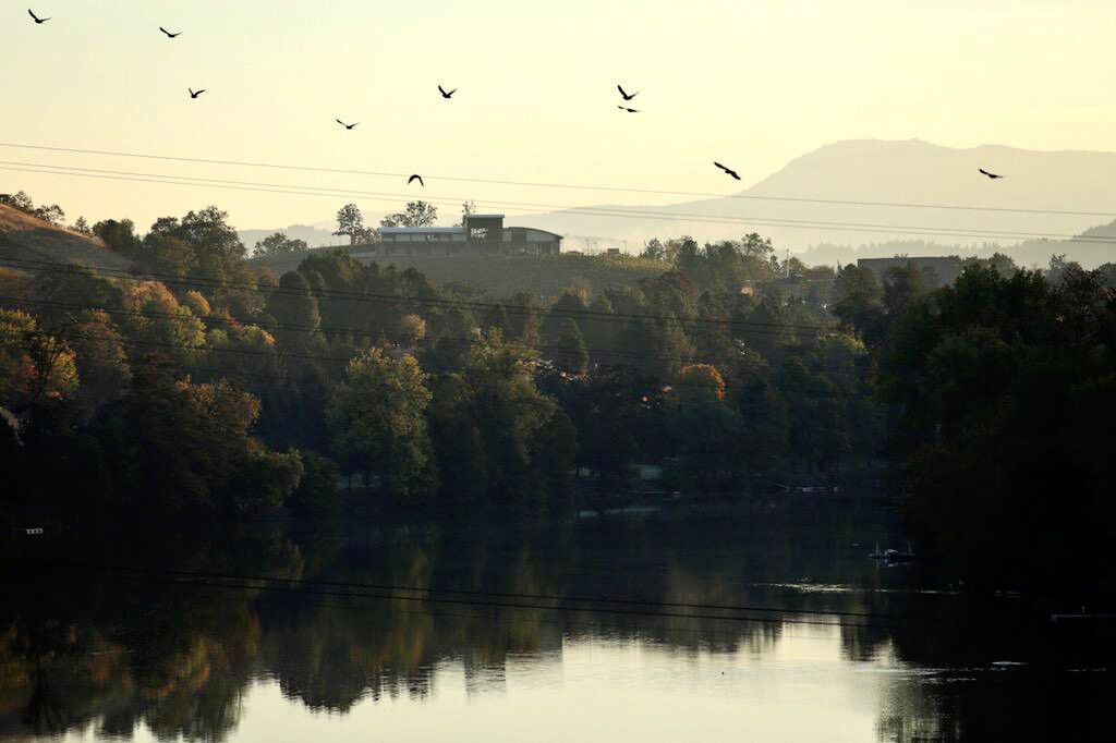 Sunrise along the North Umpqua River with Umpqua Community College in the background, Friday morning. Nine people were killed and seven injured at Umpqua Community College when Chris Harper Mercer went a shooting rampage Thursday, October 1, 2015.