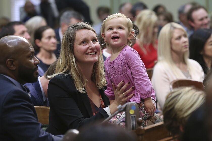 Freshman Assemblywoman Buffy Wicks, a Democrat, and her daughter, Josephine, 2, look at the Assembly Gallery during the Legislative session Monday, Dec. 3, 2018, in Sacramento, Calif. Wicks and the rest of the members of the Assembly took their oath of office to kick off the new two-year legislative session. (AP Photo/Rich Pedroncelli)