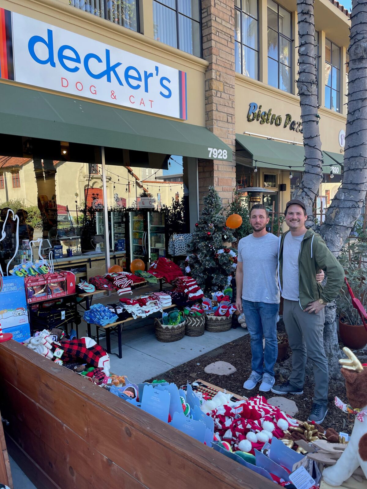 Decker's Dog & Cat employee Emerson Lowrey and owner Cody Decker set up an outdoor display for Small Business Saturday.