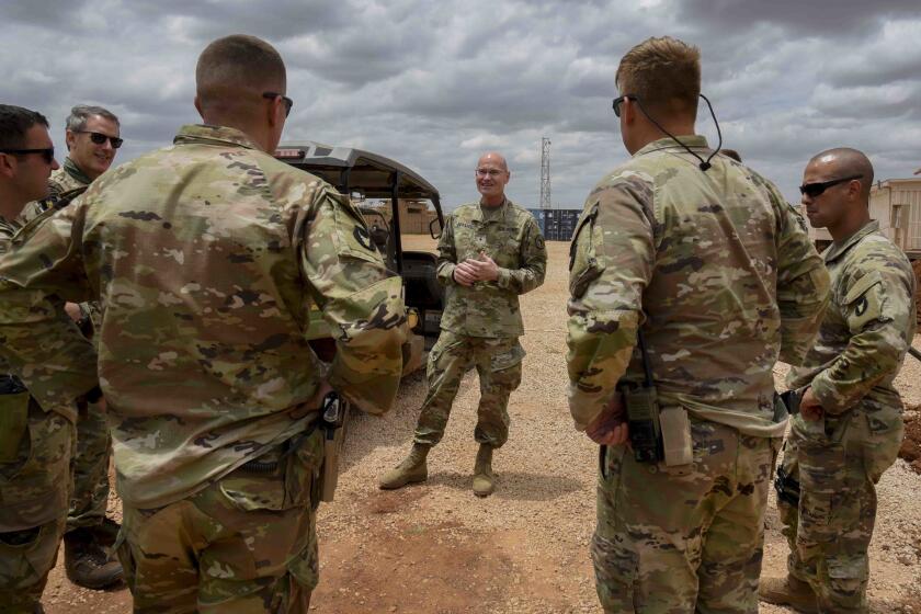 U.S. Army Brig. Gen. Damian T. Donahoe, deputy commanding general, Combined Joint Task Force - Horn of Africa, center, talks with service members during a battlefield circulation Saturday, Sept. 5, 2020, in Somalia. No country has been involved in Somalia's future as much as the United States but now the Trump administration is thinking of withdrawing the several hundred U.S. military troops from the nation at what some experts call the worst possible time. (Senior Airman Kristin Savage/Combined Joint Task Force - Horn of Africa via AP)