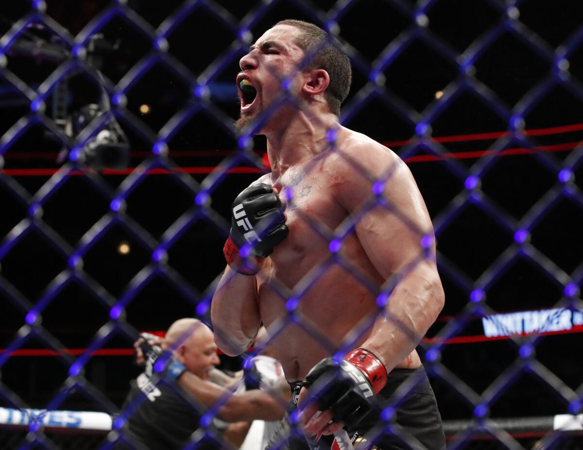 In this June 10, 2018, photo, Robert Whittaker reacts after his title bout at UFC 225 in Chicago.