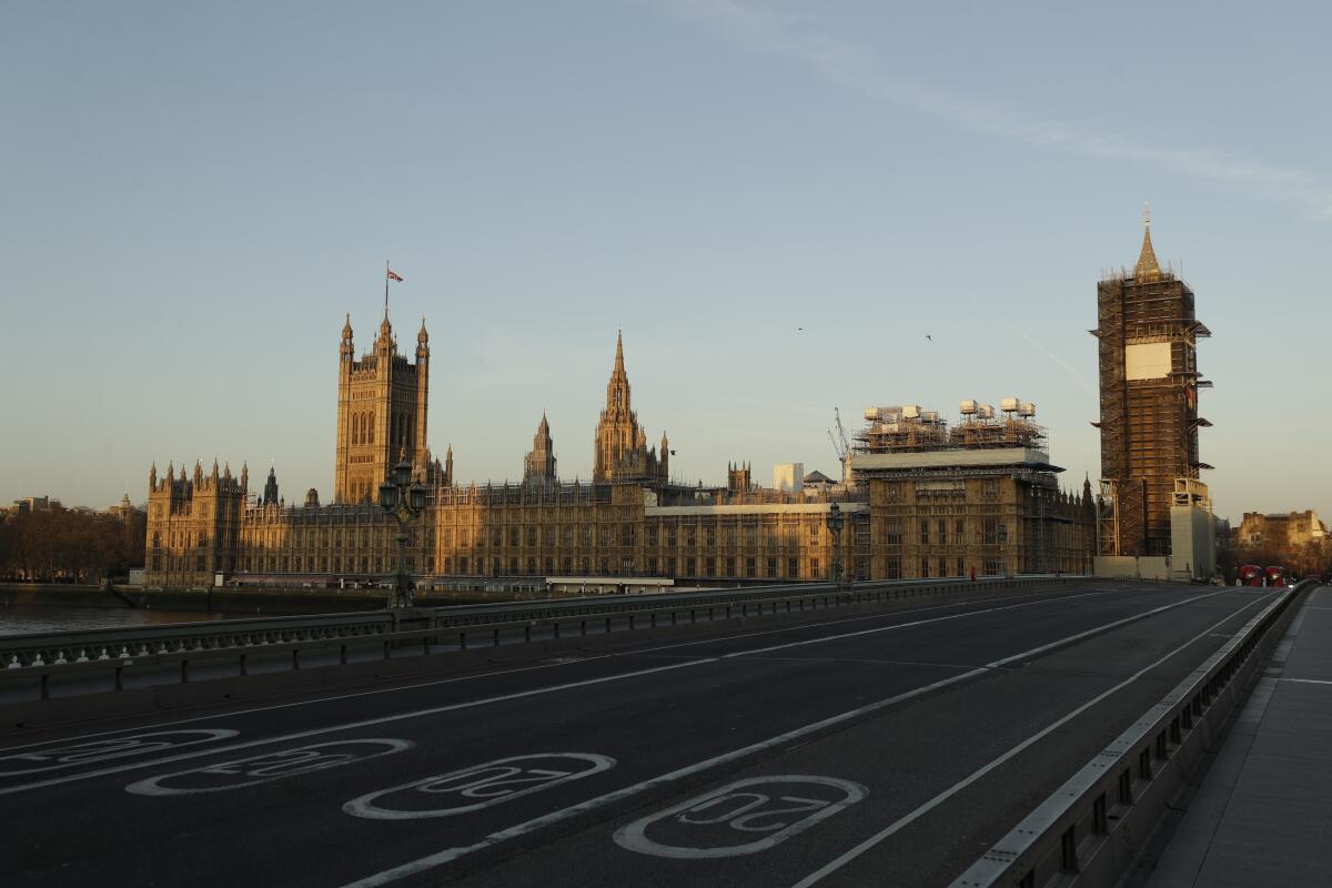 The lanes of Westminster Bridge are seen with historic buildings in the background.
