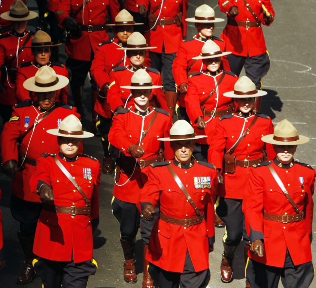 Canada's Mounties, officially the Royal Canadian Mounted Police, go back to the 1870s, and their telltale red jackets are known as "the red serge." Here, a gaggle of Mounties is seen marching through downtown Calgary in a parade that was part of the 2013 Calgary Stampede.