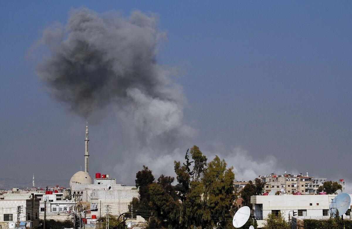 Smoke rises after a reported airstrike by the Syrian military on Daraya.