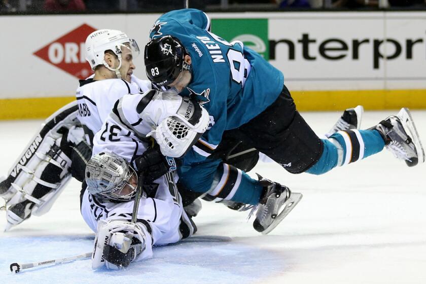 San Jose Sharks' Matt Nieto, right, collides with Kings' Brayden McNabb, left, and Jonathan Quick, bottom, in the second period in Game 4 of the first-round Western Conference playoffs on April 20.