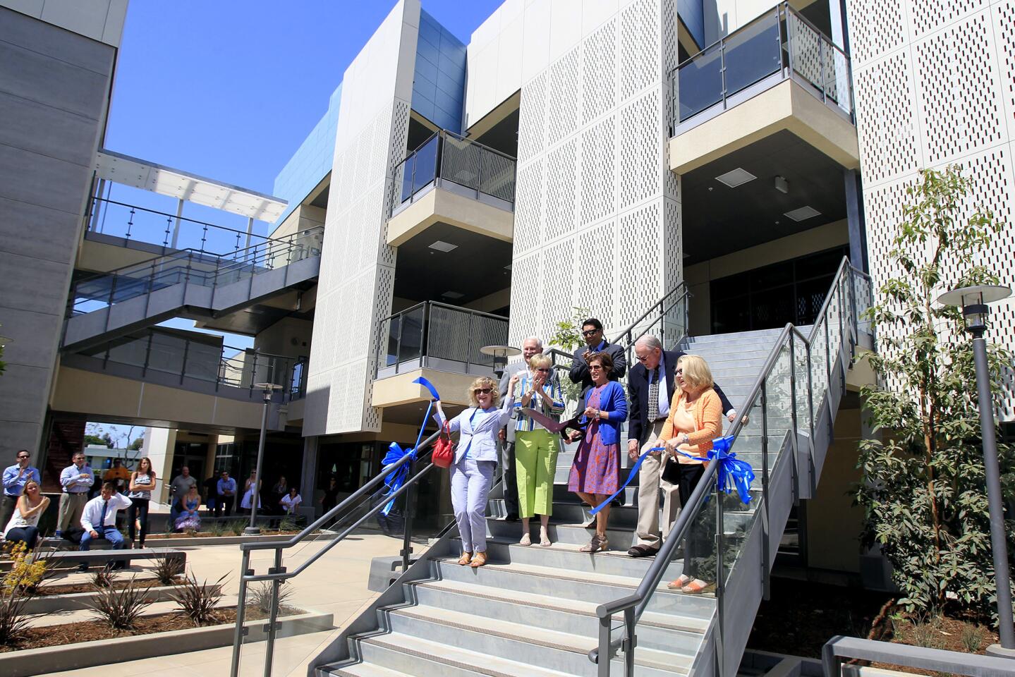 Newport-Mesa Unified School District board and staff members celebrate after a ribbon-cutting for Corona del Mar Middle School's brand new 7th- and 8th-grade enclave building on Wednesday in Newport Beach. (Kevin Chang/ Daily Pilot)