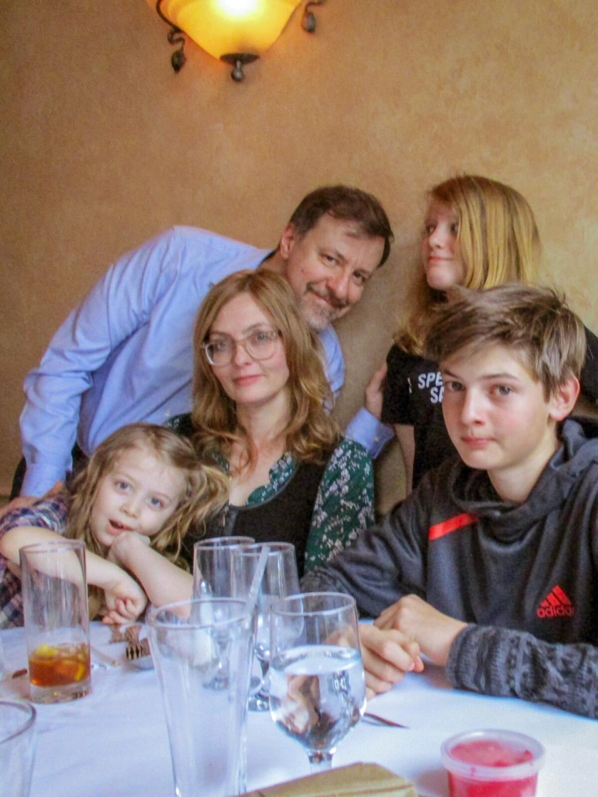 Angela and Peter Arcese of Brooklyn pose for a photograph with their children. 