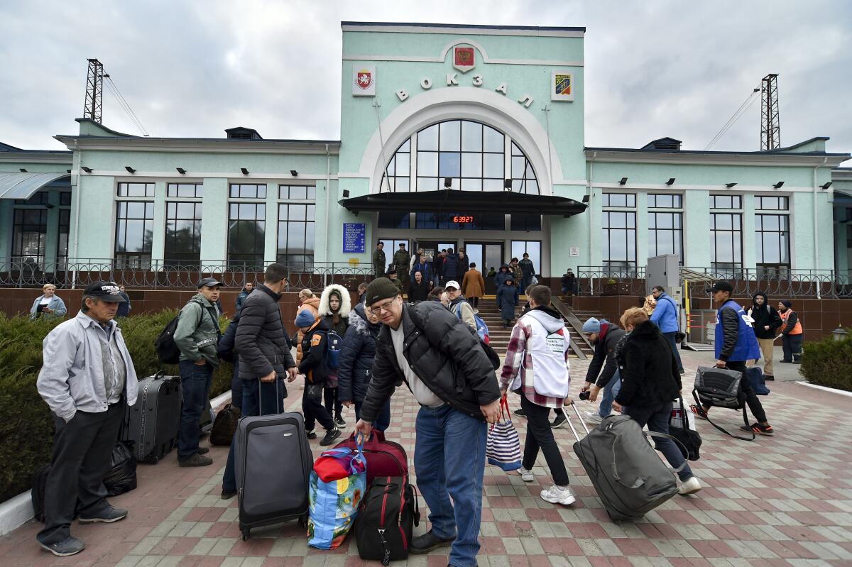 Evacuees from Kherson gather upon their arrival at the railway station.