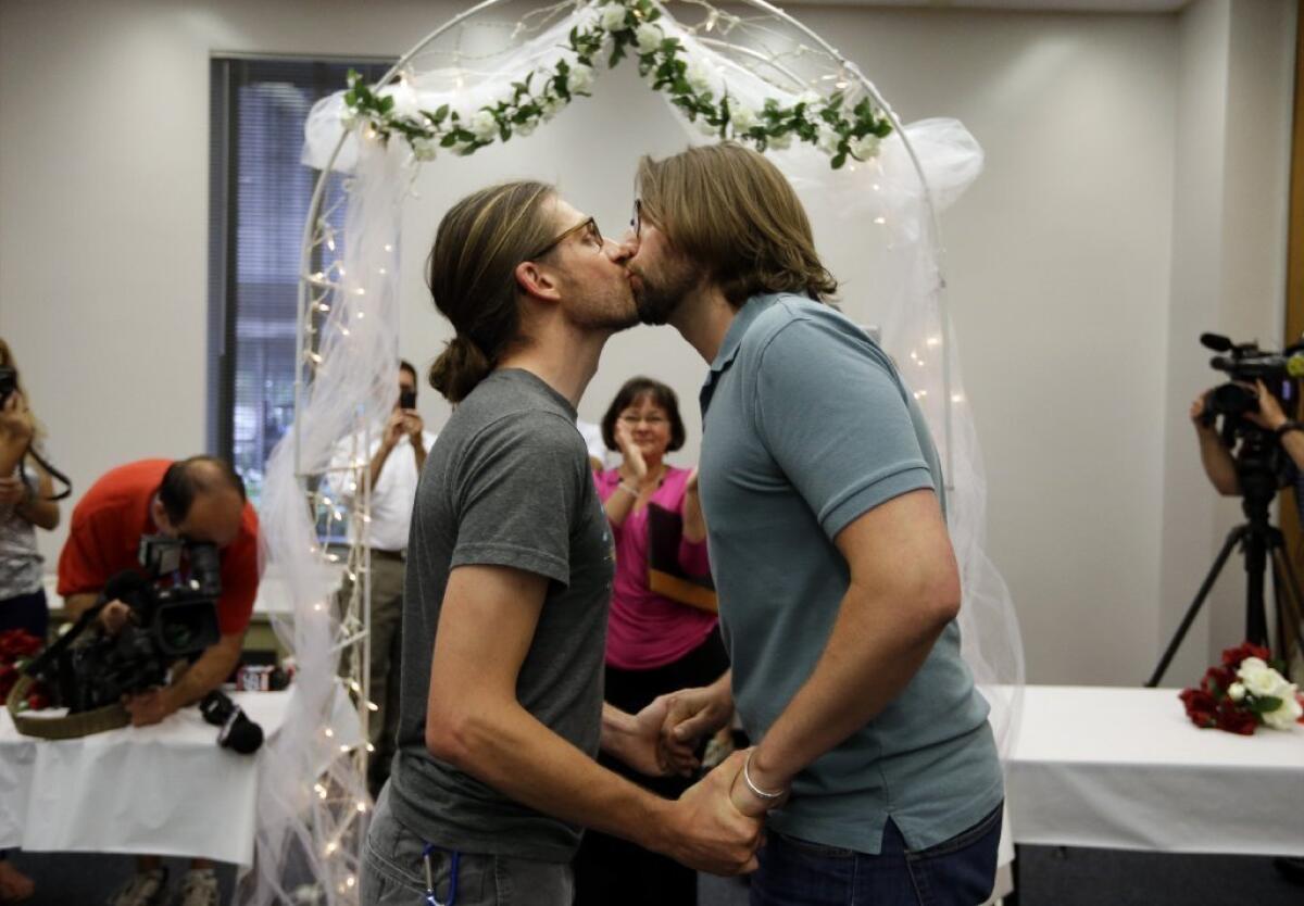 Jake Miller and Craig Bowen after being married by Marion County Clerk Beth White in Indianapolis.