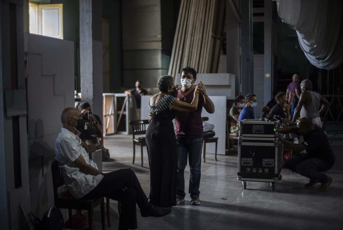 A couple dance danzón during a rehearsal with the Failde Orchestra in Matanzas, Cuba, Saturday, Oct. 2, 2021. Danzón started in the city in the late 1800s and became the national dance of Cuba, spreading to other countries in the region. (AP Photo/Ramón Espinosa)