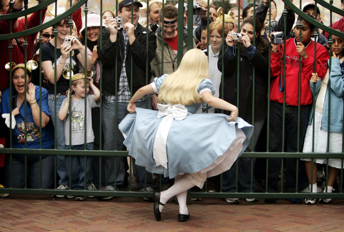 Alice in Wonderland entertains patrons waiting to get into Disneyland.