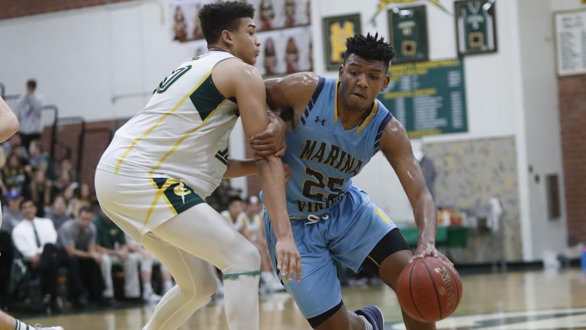 Jakob Alamudun, seen here on the right on Jan. 5, 2018, led Marina High to its first win in the CIF Southern Section playoffs since the 2008-09 season on Wednesday.