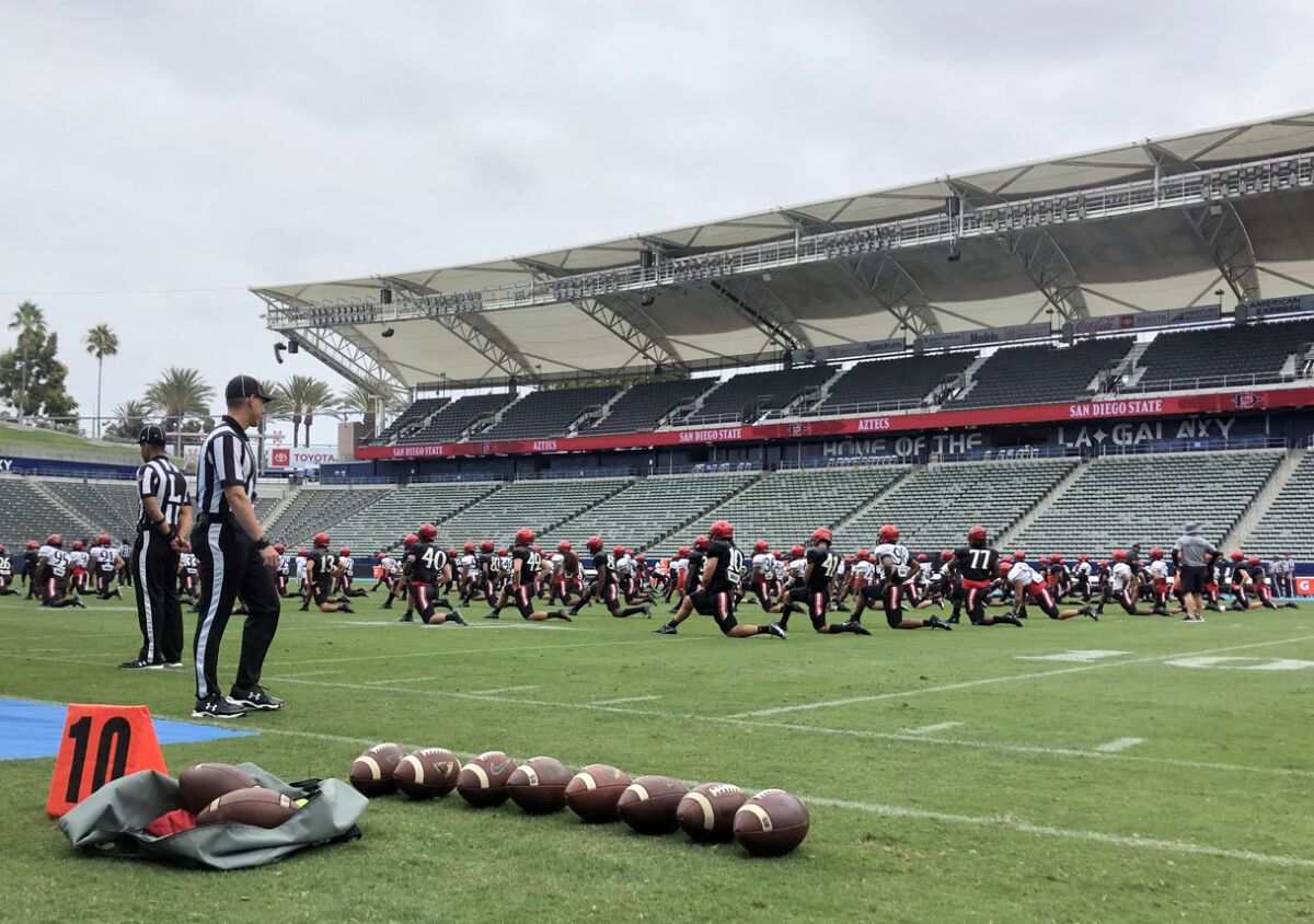 Members of the San Diego State football team on a field
