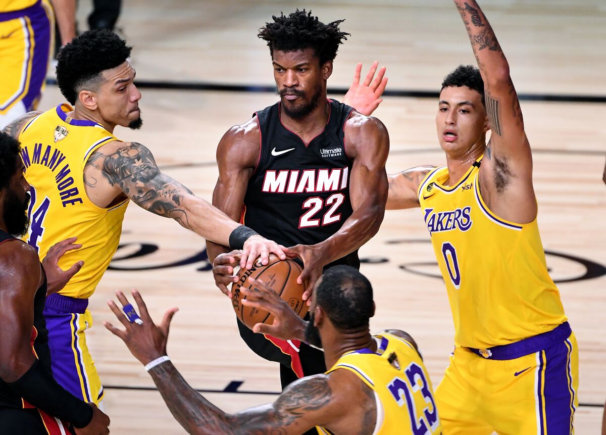 Lakers guard Danny Green, left, knocks the ball from Heat forward Jimmy Butler during Game 1 of the NBA Final.