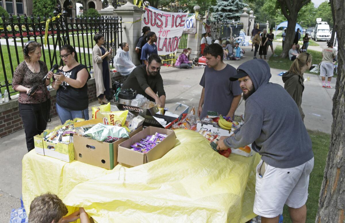 Manifestantes montan una mesa de comida afuera de la residencia del gobernador el viernes 8 de julio de 2016 en St. Paul, Minnesota, en donde las protestas contin˙an por la muerte de Philando Castile el miÈrcoles 6 de julio de 2016 en Falcon Heights. (AP Foto/Jim Mone)