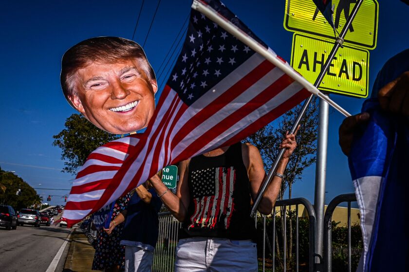Supporters of former US President Donald Trump wait to catch a glimpse of him as he arrives from New York City near Palm Beach International Airport in West Palm Beach, Florida, on April 4, 2023. - Trump pleaded not guilty to 34 felony counts inside a packed New York courtroom, in a dramatic hearing that transfixed the nation and began the countdown to the first ever criminal trial of an American president. (Photo by Giorgio Viera / AFP) (Photo by GIORGIO VIERA/AFP via Getty Images)