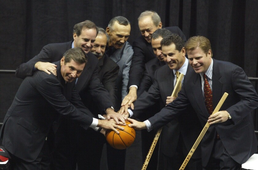 New Atlanta Hawks and Atlanta Thrashers owners, from left, Steven Belkin, J Michael Gearon Jr., Ed Peskowitz, M.B 'Bud' Seretean, J. Michael Gearon Sr, Todd Foreman, Bruce Levenson and John Rutherford Seydel pose for a picture following a press conference at Philips Arena on Sept. 16, 2003, in Atlanta. Gearon Sr., whose love for the Hawks was so great that he insisted he be paid only $1 annually when he served as an executive, died on Nov. 22 from a brain herniation while surrounded by family in his Atlanta home, the team announced Saturday, Dec. 11, 2021. He was 87. (Brant Sanderlin/Atlanta Journal-Constitution via AP)