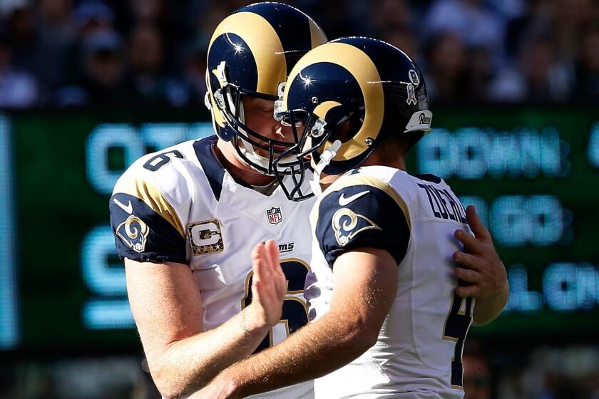 Punter and holder Johnny Hekker (6) congratulates kicker Greg Zuerlein after he scored the Rams' first points with a field goal in the first quarter Sunday.