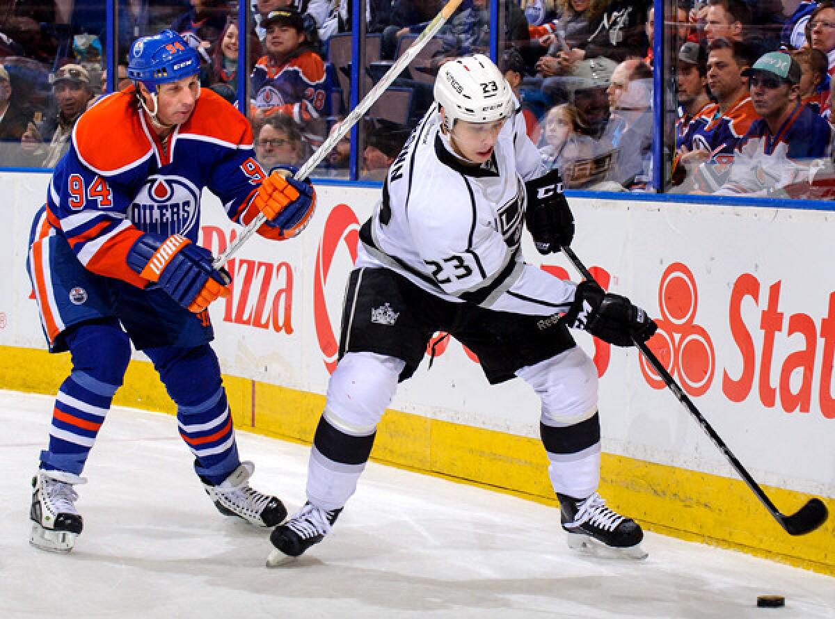 Kings winger Dustin Brown beats Oilers winger Ryan Smyth to the puck during a game earlier this month in Edmonton.
