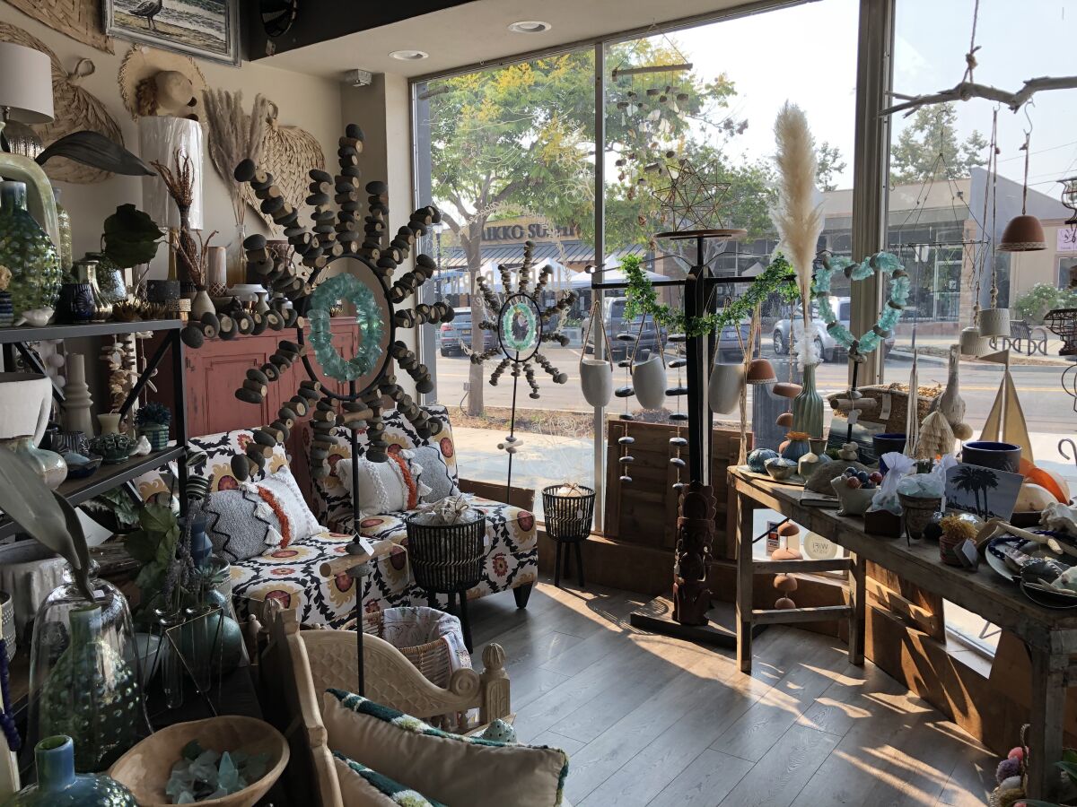 A view of Main Street seen through the windows of Urban Barn Vintage store in downtown Vista.