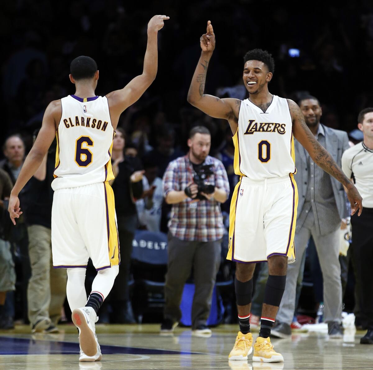 Lakers guard Jordan Clarkson (6) celebrates with guard Nick Young after defeating the Phoenix Suns, 119-108, on Nov. 6.