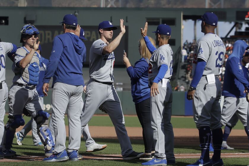 Los Angeles Dodgers players celebrate after defeating the San Francisco Giants in a baseball game in San Francisco, Sunday, Sept. 29, 2019. (AP Photo/Jeff Chiu)