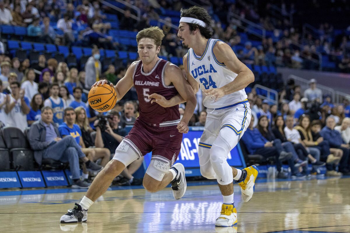 Bellarmine guard Peter Suder, left, drives to the basket against UCLA guard Jaime Jaquez Jr. during the first half of an NCAA college basketball game in Los Angeles, Sunday, Nov. 27, 2022. (AP Photo/Alex Gallardo)