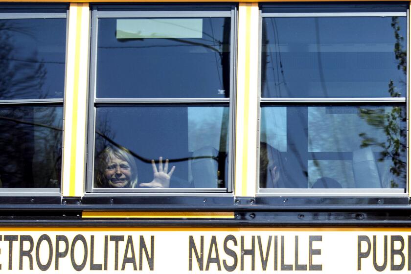 A child weeps while on the bus leaving The Covenant School following a mass shooting