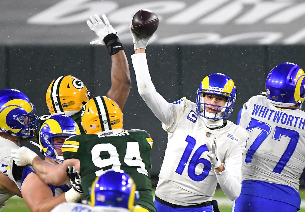 Rams quarterback Jared off gets a pass off against the Packers amid snow flurries at Lambeau Field.