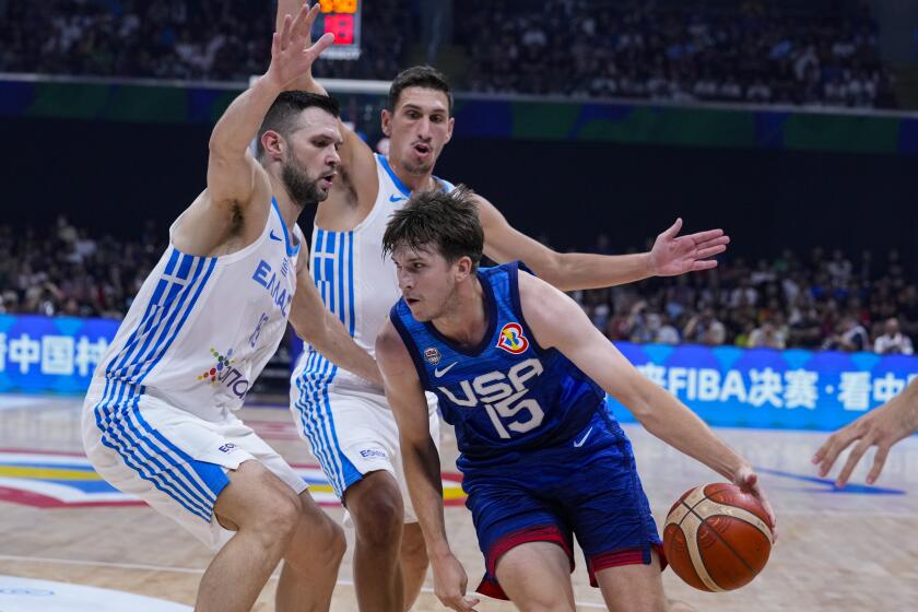U.S. guard Austin Reaves (15) drives on Greece forward Kostas Papanikolaou (16) during the first half of a Basketball World Cup group C match in Manila, Philippines Monday, Aug. 28, 2023.(AP Photo/Michael Conroy)