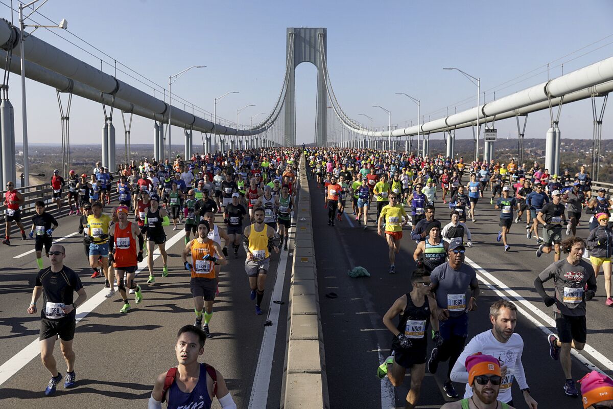 FILE - Runners make their way across the Verrazzano-Narrows Bridge during the start of the New York City Marathon, Sunday, Nov. 3, 2019, in New York. A limited field of 33,000 runners will jog off the Verrazzano Bridge and wind its way toward Central Park on Sunday, Nov. 7, as the New York City Marathon returns for its 50th edition after being wiped out in 2020 by the coronavirus pandemic. (AP Photo/Julius Motal, File)