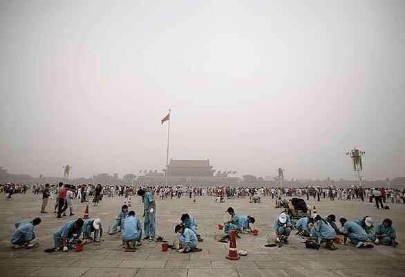 Workers clean Beijing's Tiananmen Square