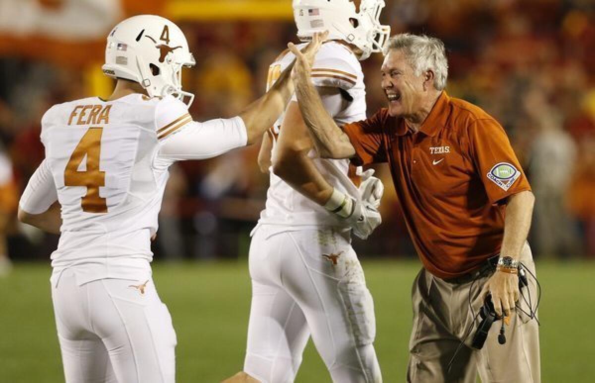 Texas Coach Mack Brown, right, celebrates with kicker Anthony Fera during the Longhorns' win over Iowa State.
