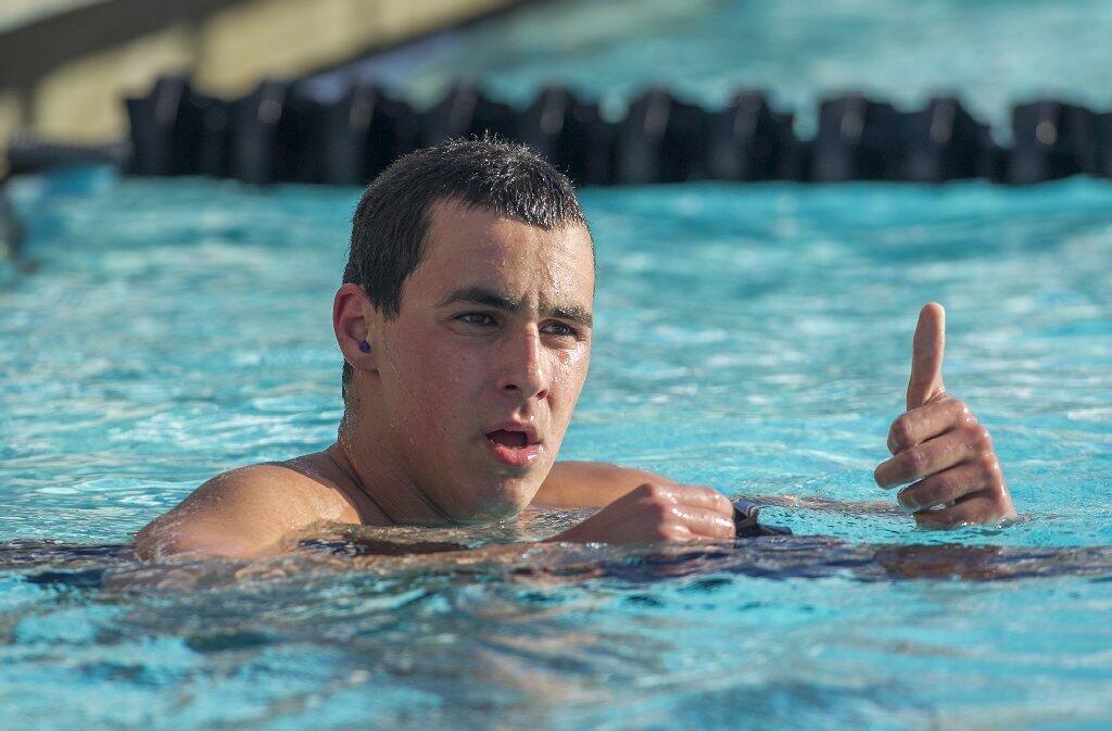 Corona del Mar's Robert Genc gives a thumbs up after winning the 500-yard freestyle during a Pacific Coast League meet against Irvine at Woollett Aquatic Center on Wednesday.