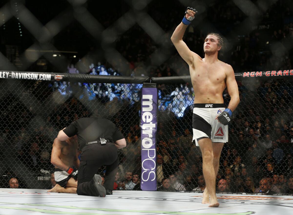 Brian Ortega, right, celebrates after defeating Diego Brandao during a featherweight mixed martial arts bout at UFC 195, Saturday, Jan. 2, 2016, in Las Vegas.