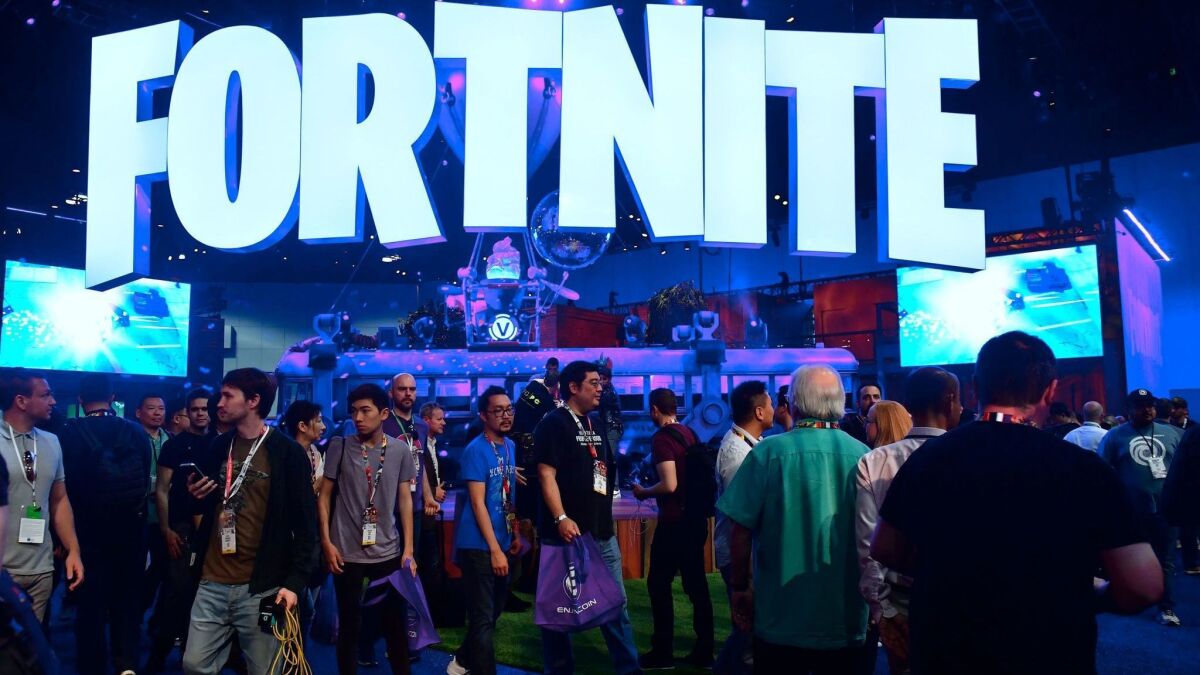 People crowd the display area for the survival game "Fortnite" at E3 2018 in Los Angeles on June 18.
