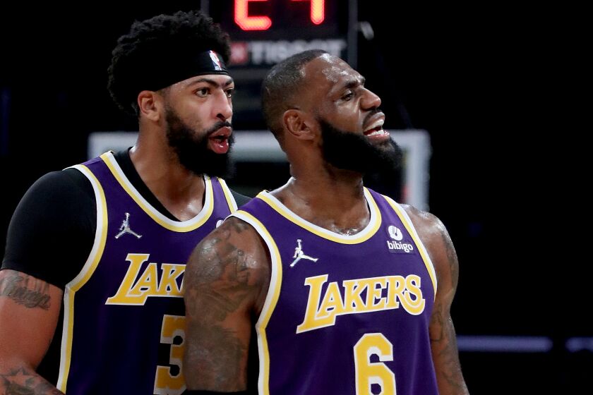 LOS ANGELES, CALIF. - OCT. 29, 2021. Lakers forward Anthony Davis talks with teammate LeBron James.