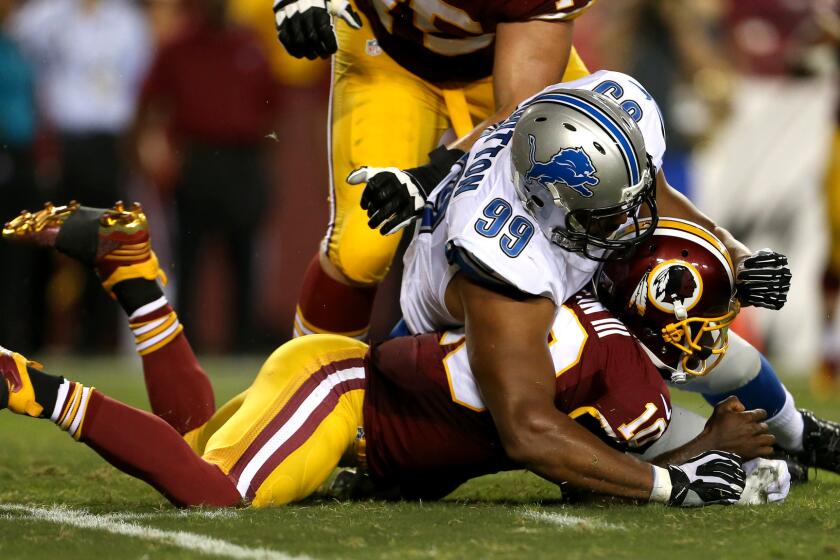 Washington quarterback Robert Griffin III is injured when trying to recover a fumble as Lions defensive lineman Corey Wootton lands on him.