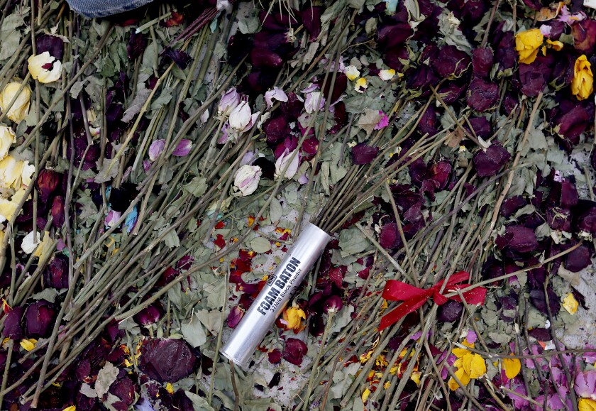 A shell casing serves as a vase for flowers amid a Black Lives Matter protest in downtown L.A.