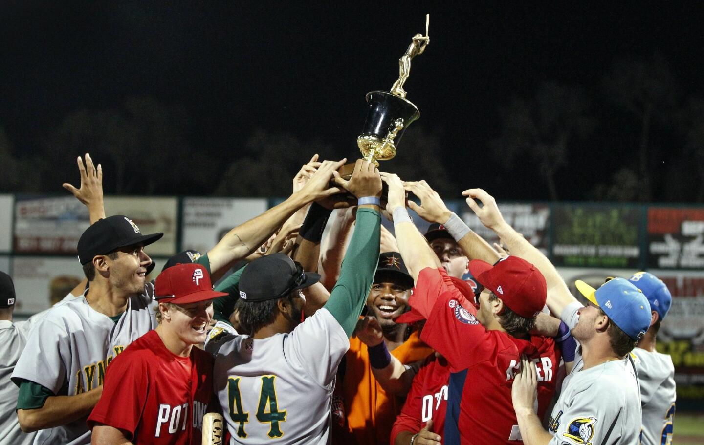 Carolina League players hold up the trophy after beating California 6-4 during the Carolina/California All-Star Game at The Diamond in Lake Elsinore on Tuesday.