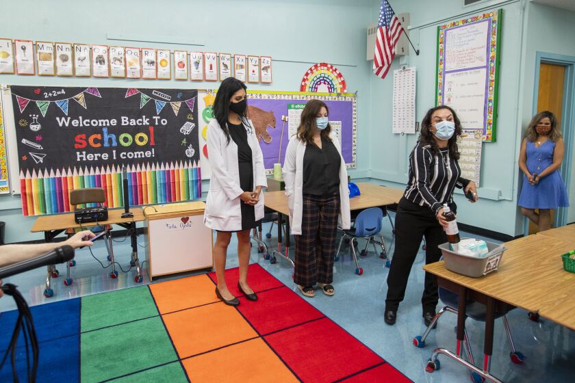 Los Angeles, CA - July 26: Dr. Smita Malhotra, left, medical director, and Dr. Rosina Franco, middle, listen to Josefina Flores, right, Euclid Avenue Elementary School principal, speak in a classroom at a L.A. Unified "meet and greet" with its medical advisors as they answer questions and present the safety preparations at Euclid Avenue Elementary School Monday, July 26, 2021 in Los Angeles, CA. Parents have until Friday to choose whether to return their children to in-person classes or remain online in the fall. The first day of school is in mid-August. (Allen J. Schaben / Los Angeles Times)